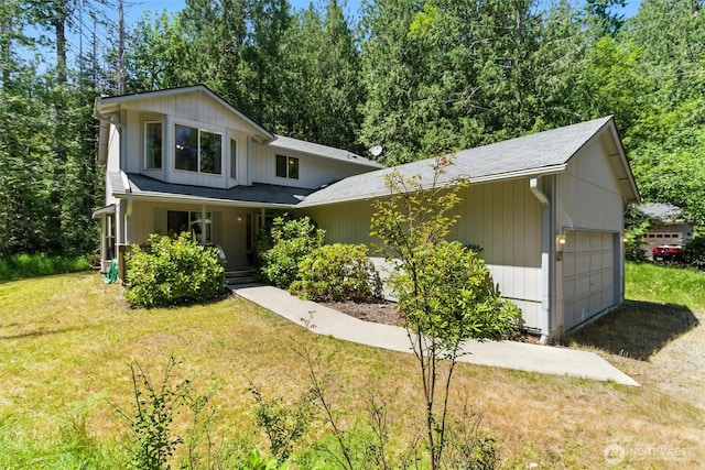 127 E Barnacle Blvd, Shelton, WA 98584 - view of front of home with covered porch, a garage, a front lawn, and driveway