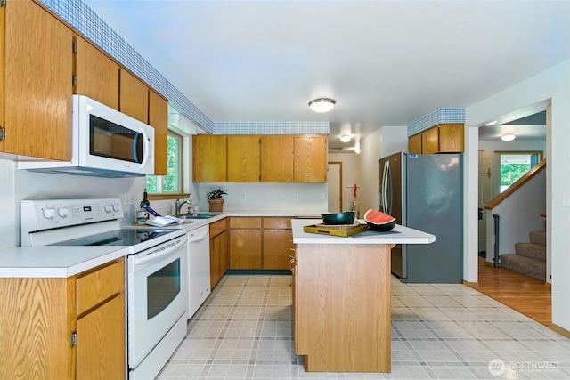 127 E Barnacle Blvd, Shelton, WA 98584 - kitchen featuring white appliances, light countertops, a center island, and plenty of natural light