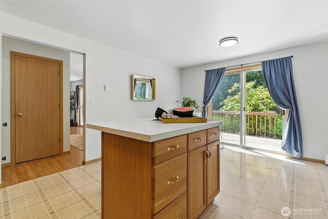 127 E Barnacle Blvd, Shelton, WA 98584 - kitchen featuring light countertops, a kitchen island, and brown cabinets