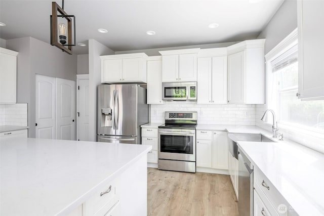 7830 A St, Tacoma, WA 98408 - kitchen featuring stainless steel appliances, backsplash, white cabinets, and recessed lighting