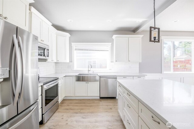 7830 A St, Tacoma, WA 98408 - kitchen featuring appliances with stainless steel finishes, light countertops, white cabinets, and recessed lighting