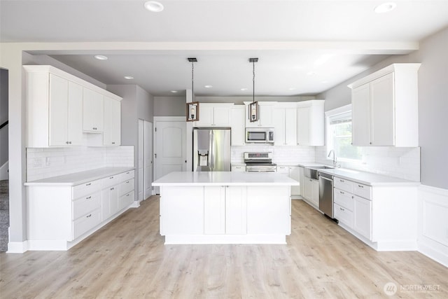 7830 A St, Tacoma, WA 98408 - kitchen featuring stainless steel appliances, tasteful backsplash, a center island, white cabinets, and recessed lighting