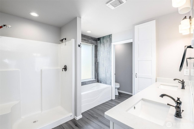 7830 A St, Tacoma, WA 98408 - bathroom featuring wood finished floors, double vanity, a shower, a bath, and recessed lighting