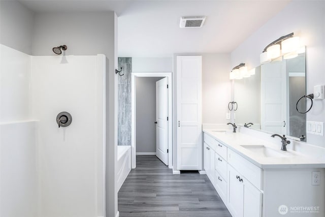 7830 A St, Tacoma, WA 98408 - full bath with double vanity, wood finished floors, and washtub / shower combination