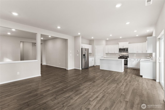 3929 23rd Ave NE Unit 99, Olympia, WA 98506 - kitchen with stainless steel appliances, open floor plan, dark wood-type flooring, a kitchen island, and light countertops