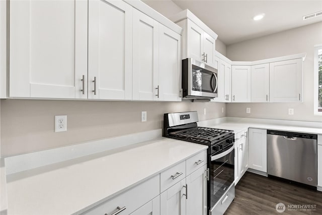 3929 23rd Ave NE Unit 99, Olympia, WA 98506 - kitchen featuring appliances with stainless steel finishes, light countertops, white cabinetry, recessed lighting, and dark wood finished floors