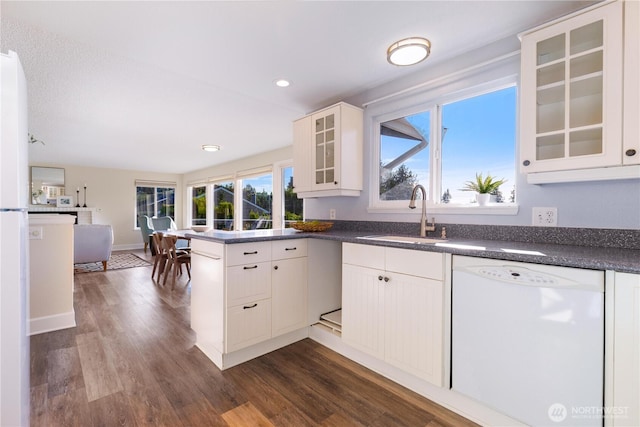 1418 W Mukilteo Blvd, Everett, WA 98203 - kitchen with dishwasher, dark countertops, dark wood-type flooring, glass insert cabinets, and a peninsula