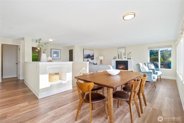 1418 W Mukilteo Blvd, Everett, WA 98203 - dining area featuring light wood finished floors and a glass covered fireplace