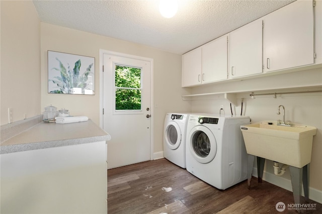 1418 W Mukilteo Blvd, Everett, WA 98203 - laundry area with cabinet space, washing machine and dryer, wood finished floors, and a textured ceiling