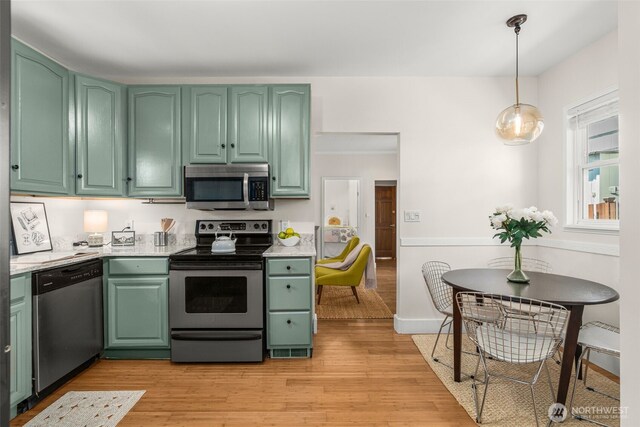 4506 46th Ave SW, Seattle, WA 98116 - kitchen featuring stainless steel appliances, green cabinetry, and light countertops