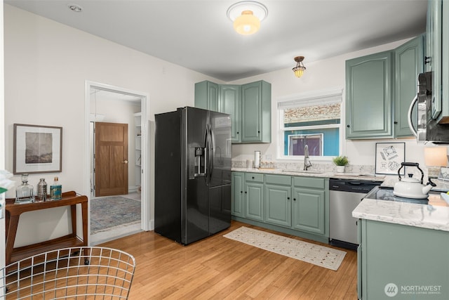 4506 46th Ave SW, Seattle, WA 98116 - kitchen with appliances with stainless steel finishes, green cabinetry, and light wood-style flooring