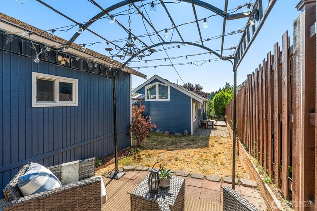 4506 46th Ave SW, Seattle, WA 98116 - fenced backyard featuring an outdoor hangout area and a patio