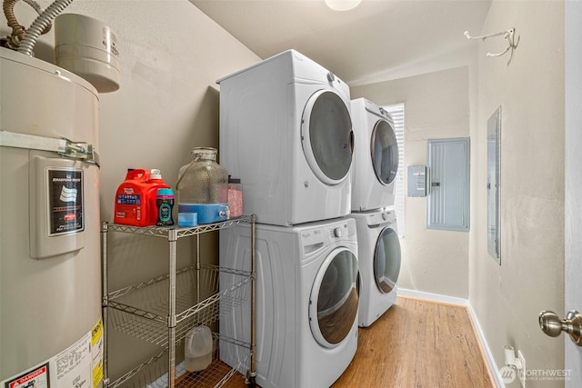 3302 W Tapps Dr E, Lake Tapps, WA 98391 - washroom with stacked washing machine and dryer, water heater, wood finished floors, and electric panel