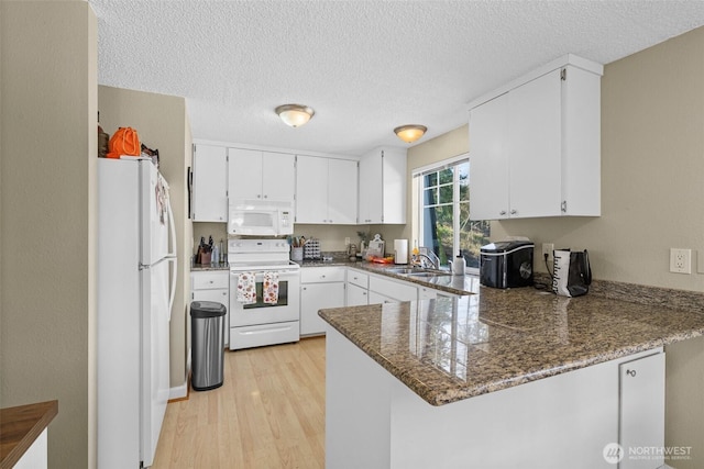 3302 W Tapps Dr E, Lake Tapps, WA 98391 - kitchen featuring white appliances, a peninsula, light wood-type flooring, white cabinetry, and a textured ceiling