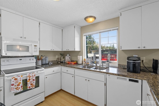 3302 W Tapps Dr E, Lake Tapps, WA 98391 - kitchen featuring white appliances, a textured ceiling, white cabinetry, light wood finished floors, and dark countertops