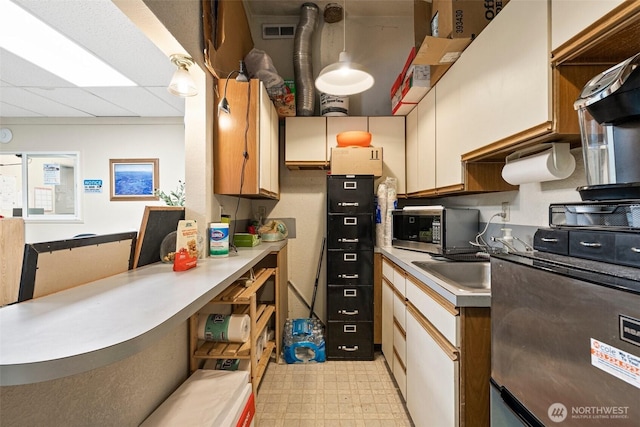 3302 W Tapps Dr E, Lake Tapps, WA 98391 - kitchen with stainless steel microwave, light countertops, light floors, and open shelves