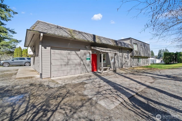 3302 W Tapps Dr E, Lake Tapps, WA 98391 - view of home's exterior with an attached garage, mansard roof, and driveway