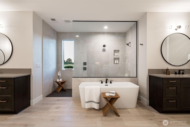 332 138th Pl SE, Auburn, WA 98092 - bathroom with a walk in shower, a soaking tub, vanity, and wood finished floors