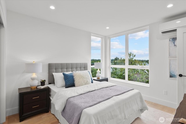 747 N 71st St, Seattle, WA 98103 - bedroom featuring a wall unit AC, light wood-style flooring, and recessed lighting