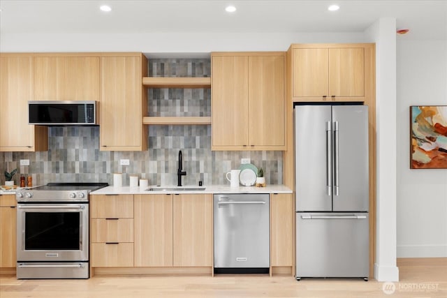 747 N 71st St, Seattle, WA 98103 - kitchen with appliances with stainless steel finishes, light brown cabinets, light countertops, backsplash, and recessed lighting