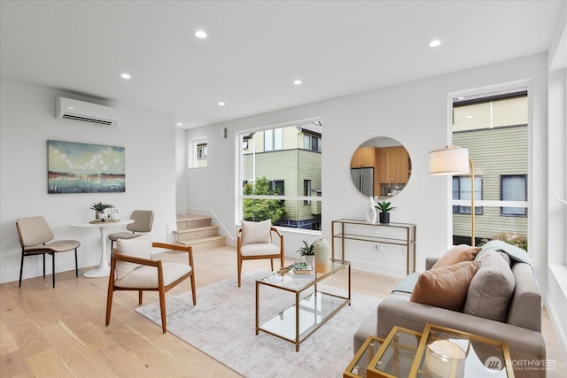747 N 71st St, Seattle, WA 98103 - living room with a wall mounted air conditioner, recessed lighting, light wood-style flooring, and stairs