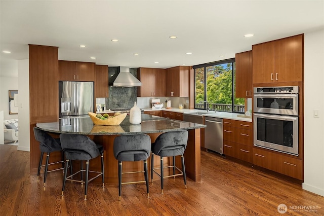 19081 11th Ave NW, Shoreline, WA 98177 - kitchen with stainless steel appliances, wall chimney exhaust hood, dark wood-style flooring, a kitchen island, and tasteful backsplash