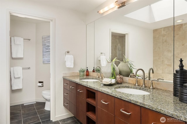 19081 11th Ave NW, Shoreline, WA 98177 - full bathroom with double vanity, tile patterned flooring, and a skylight