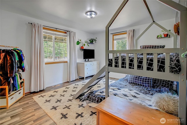 12310 Morris Rd SE, Yelm, WA 98597 - bedroom with multiple windows and wood finished floors