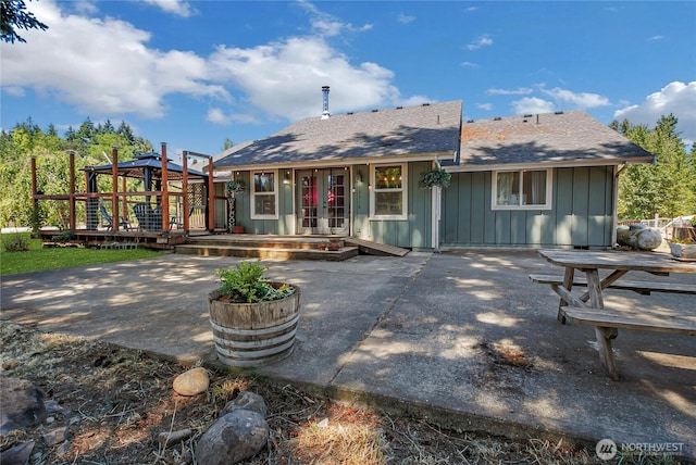 12310 Morris Rd SE, Yelm, WA 98597 - back of property featuring board and batten siding, french doors, a patio, a wooden deck, and a gazebo