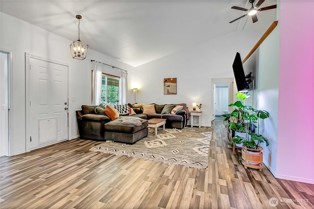 12310 Morris Rd SE, Yelm, WA 98597 - living area with wood finished floors, lofted ceiling, ceiling fan, and a chandelier