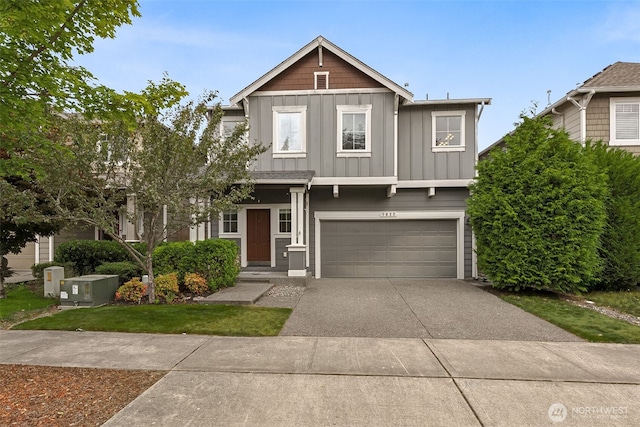 7022 Raptor Ave NE, Lacey, WA 98516 - view of front of property with board and batten siding, a garage, and concrete driveway