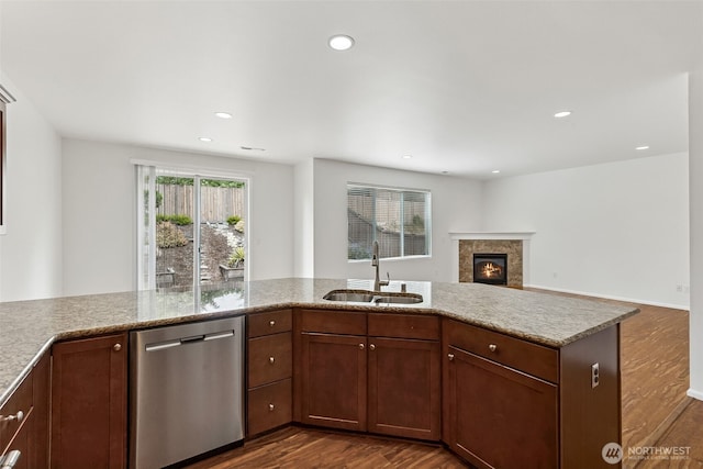 7022 Raptor Ave NE, Lacey, WA 98516 - kitchen featuring stainless steel dishwasher, dark wood-style flooring, a fireplace, open floor plan, and recessed lighting
