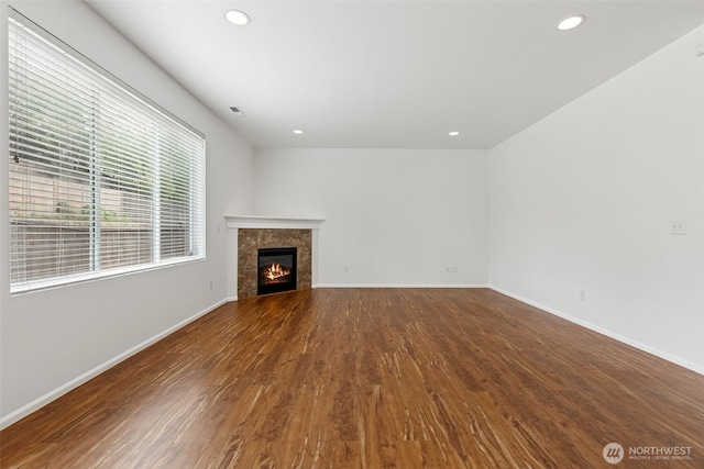 7022 Raptor Ave NE, Lacey, WA 98516 - unfurnished living room featuring wood finished floors, recessed lighting, and a tiled fireplace