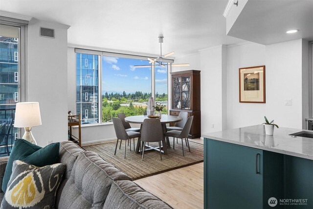 177 107th Ave NE Unit 1906, Bellevue, WA 98004 - dining space with light wood-style flooring and a chandelier