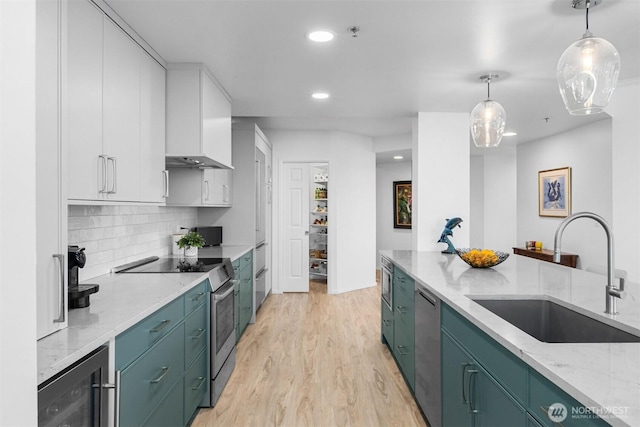 177 107th Ave NE Unit 1906, Bellevue, WA 98004 - kitchen with stainless steel appliances, beverage cooler, light wood-style floors, white cabinets, and recessed lighting
