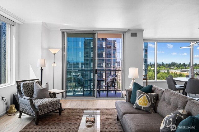 177 107th Ave NE Unit 1906, Bellevue, WA 98004 - living area featuring wood finished floors, ornamental molding, and expansive windows