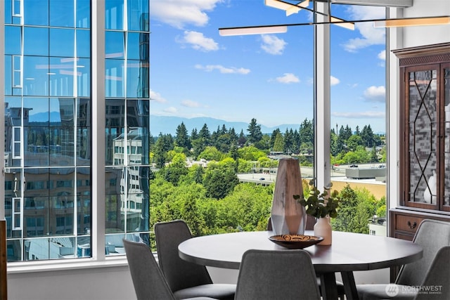 177 107th Ave NE Unit 1906, Bellevue, WA 98004 - dining space featuring a chandelier, plenty of natural light, and a mountain view