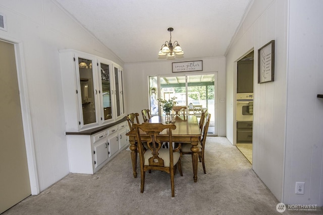 1729 154th St S, Spanaway, WA 98387 - dining area with light carpet, lofted ceiling, a chandelier, ornamental molding, and a textured ceiling
