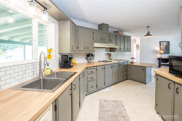 1729 154th St S, Spanaway, WA 98387 - kitchen featuring gray cabinetry, decorative backsplash, black microwave, light flooring, and a textured ceiling