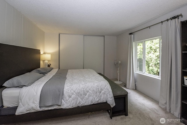 1729 154th St S, Spanaway, WA 98387 - bedroom featuring a textured ceiling, a closet, and light carpet