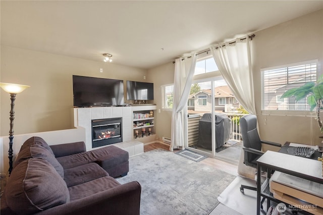 6137 Hazel Loop SE Unit D, Auburn, WA 98092 - living area with a tile fireplace, wood finished floors, and a baseboard radiator
