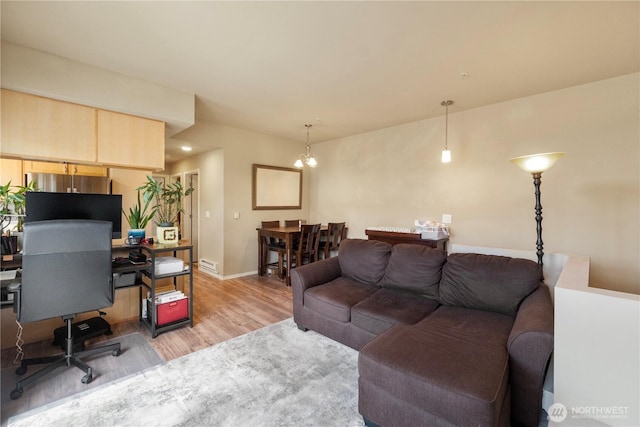 6137 Hazel Loop SE Unit D, Auburn, WA 98092 - living area with light wood-type flooring and a chandelier