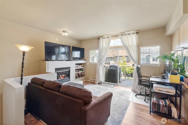 6137 Hazel Loop SE Unit D, Auburn, WA 98092 - living area with a tile fireplace, wood finished floors, an office area, and baseboard heating