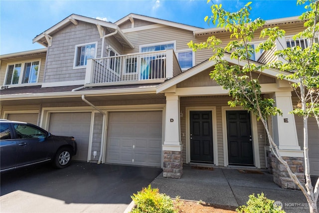 6137 Hazel Loop SE Unit D, Auburn, WA 98092 - townhome / multi-family property with a balcony, an attached garage, driveway, and stone siding