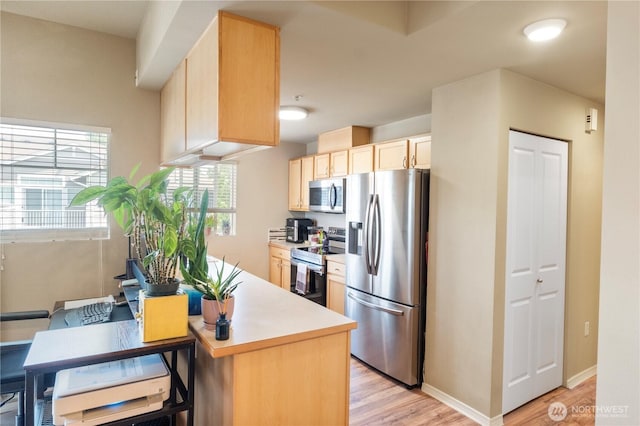 6137 Hazel Loop SE Unit D, Auburn, WA 98092 - kitchen featuring appliances with stainless steel finishes, light wood finished floors, light brown cabinetry, light countertops, and an office area