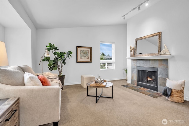 1780 W Sunn Fjord Ln Unit E306, Bremerton, WA 98312 - carpeted living area featuring a tiled fireplace, vaulted ceiling, and rail lighting