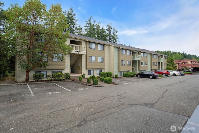 1780 W Sunn Fjord Ln Unit E306, Bremerton, WA 98312 - view of building exterior with uncovered parking and a residential view