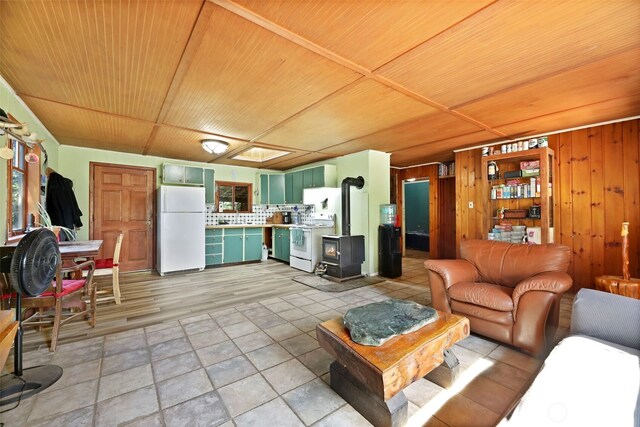 30124 Ramstad Rd, Arlington, WA 98223 - living area with wooden ceiling, a wood stove, and wooden walls