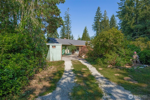 30124 Ramstad Rd, Arlington, WA 98223 - view of front of home with driveway and a chimney