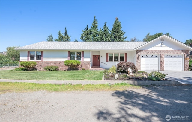 3716 Knowles Rd, Wenatchee, WA 98801 - ranch-style home featuring brick siding, an attached garage, driveway, and a front lawn